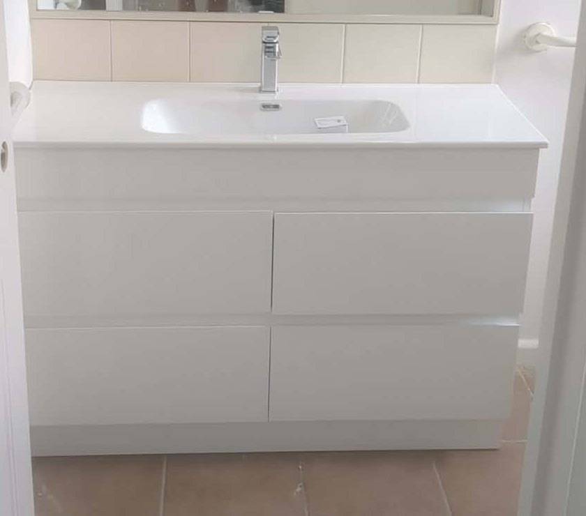 New white bathroom vanity installed and connected in the Newport home