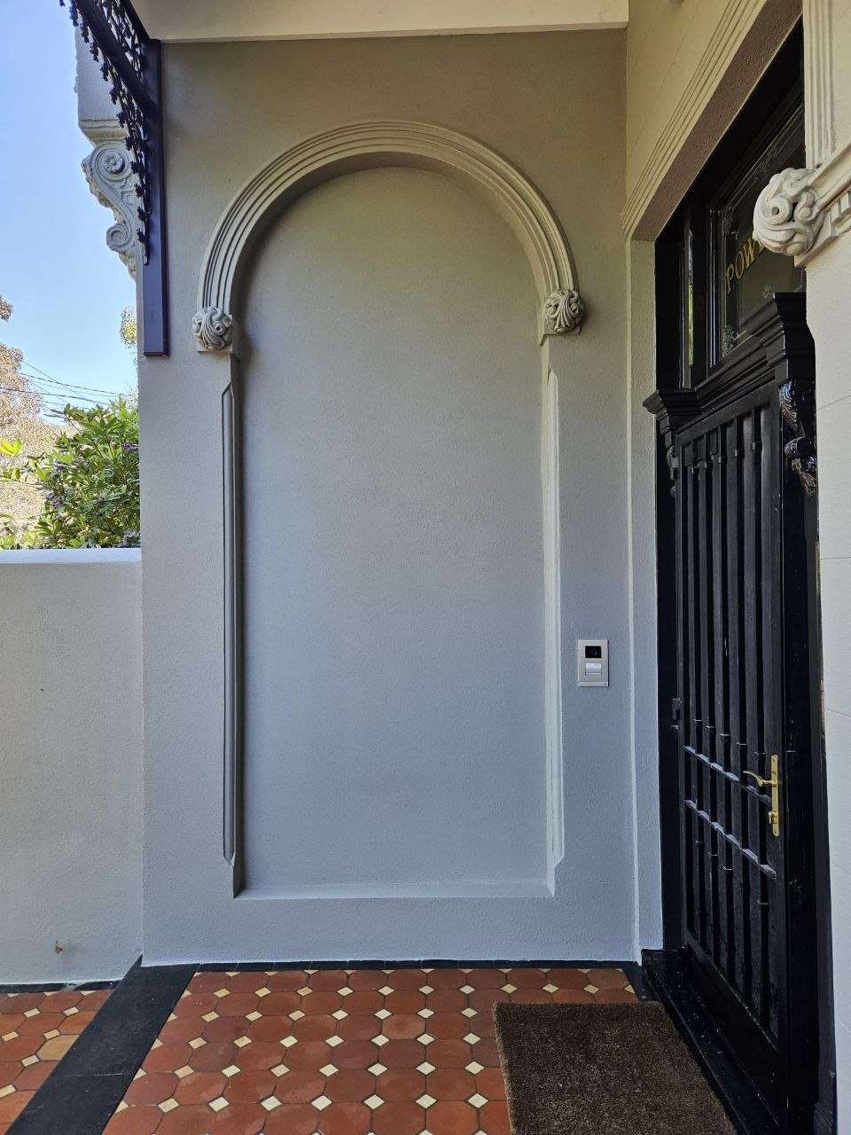 Restored arched alcove with decorative render mouldings on Victorian terrace, Melbourne VIC