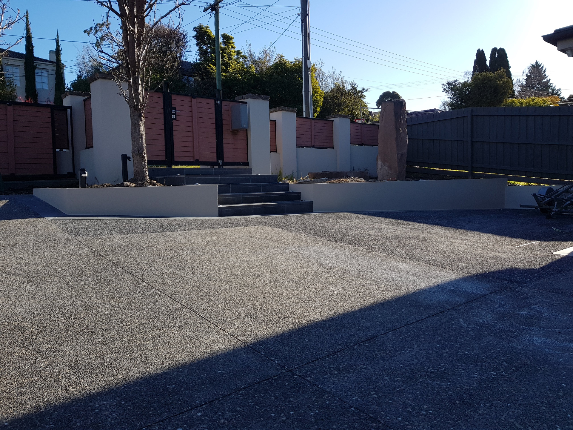 Rendered front fence pillars and retaining walls with timber gate, Melbourne VIC