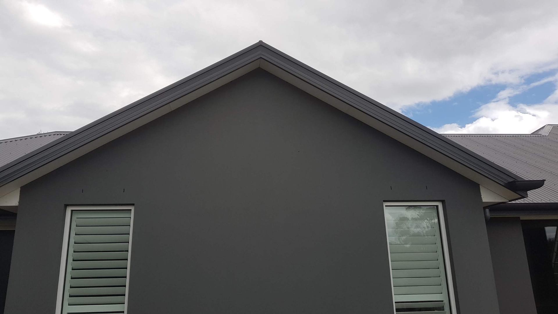 Charcoal acrylic rendered gable end with crisp paint and clean lines, Melbourne VIC