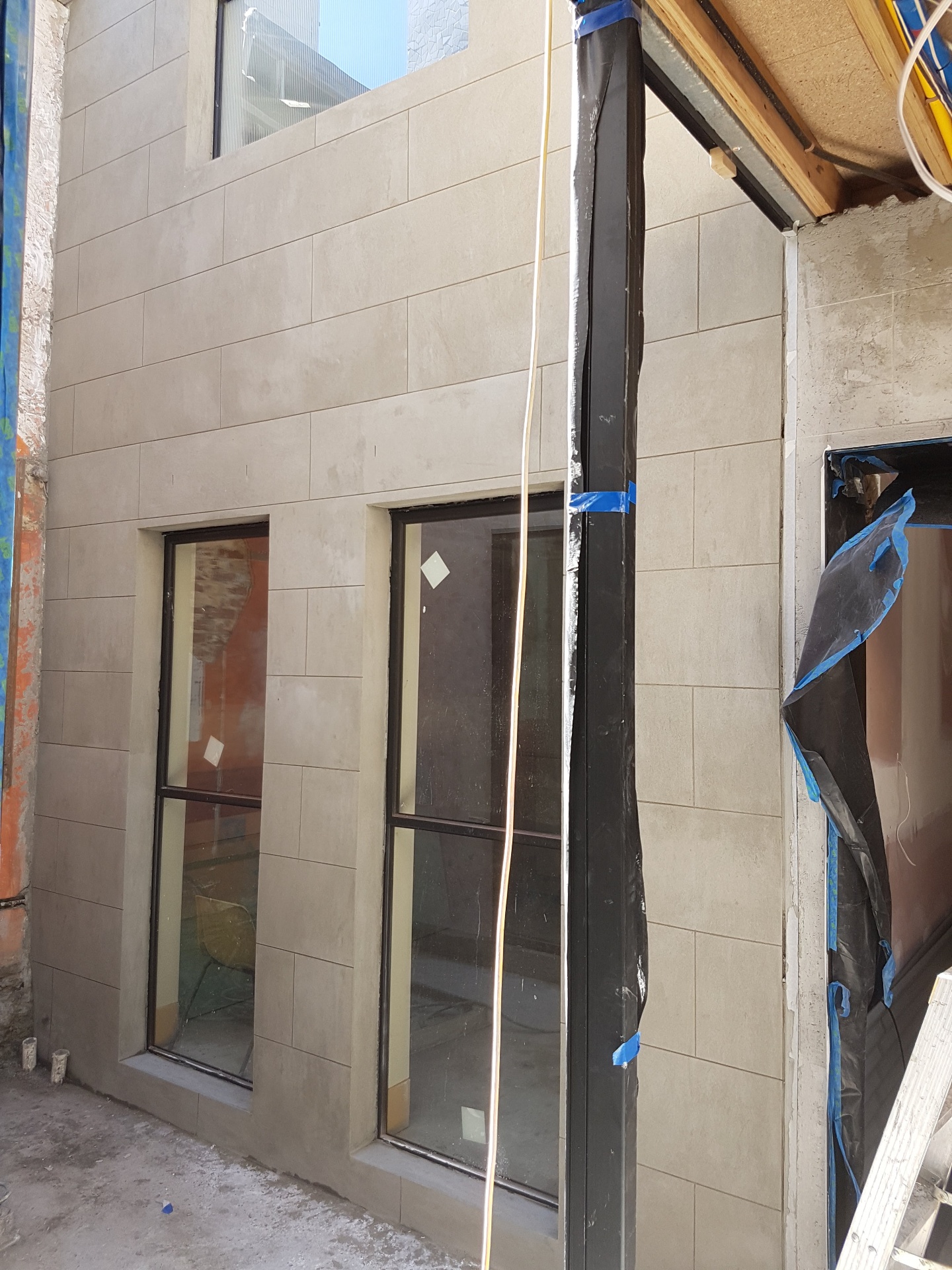 Architectural scored panel render finish around tall window openings, Melbourne VIC