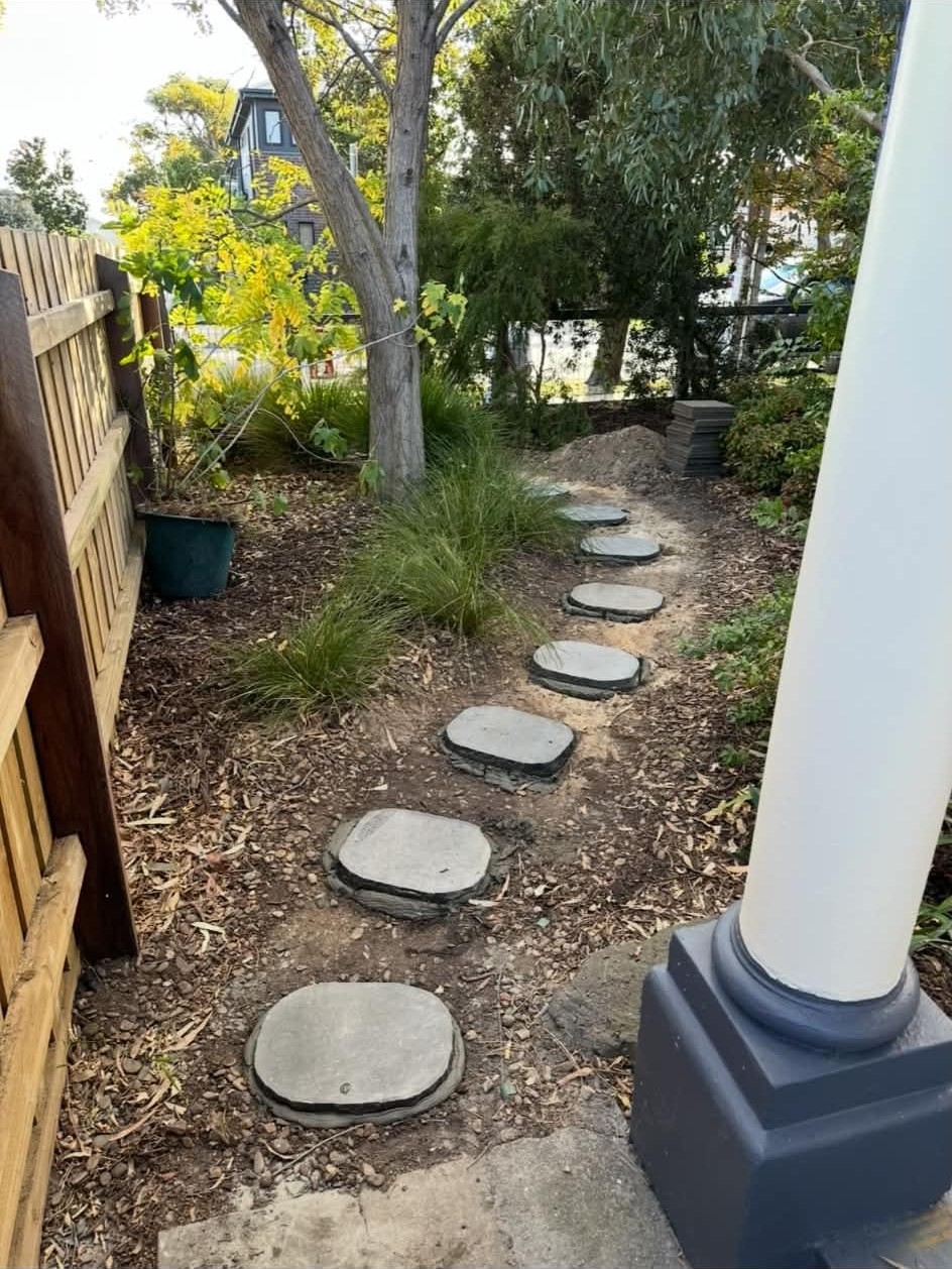 Completed bluestone stepping-stone path set level along the side of the Newport home, leading to the front verandah