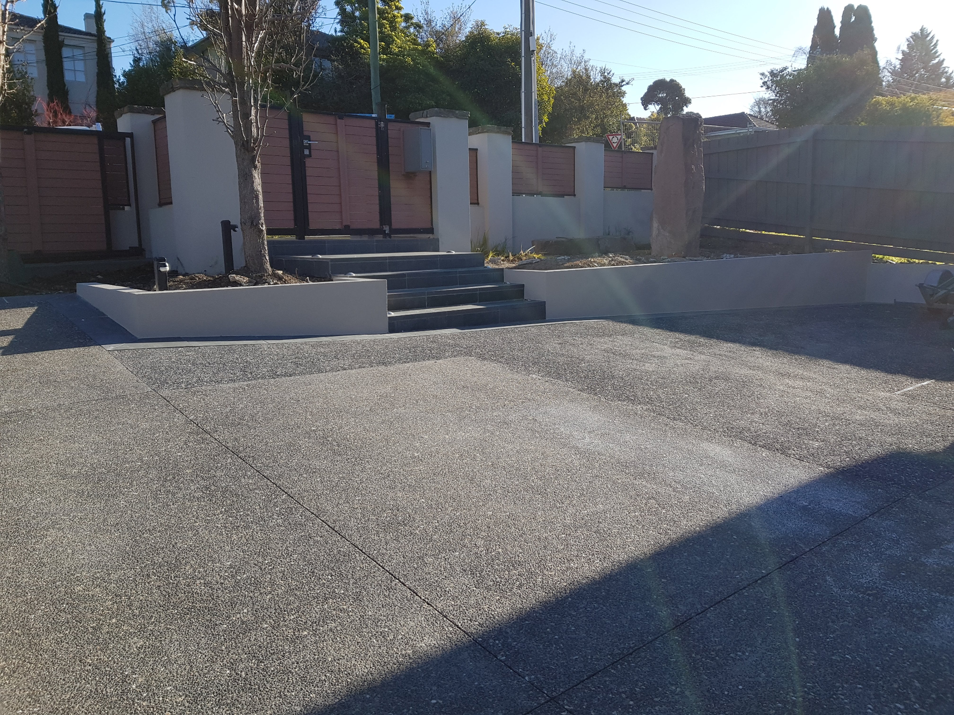 Rendered entry walls and pillars with tiled steps and exposed aggregate driveway, Melbourne VIC