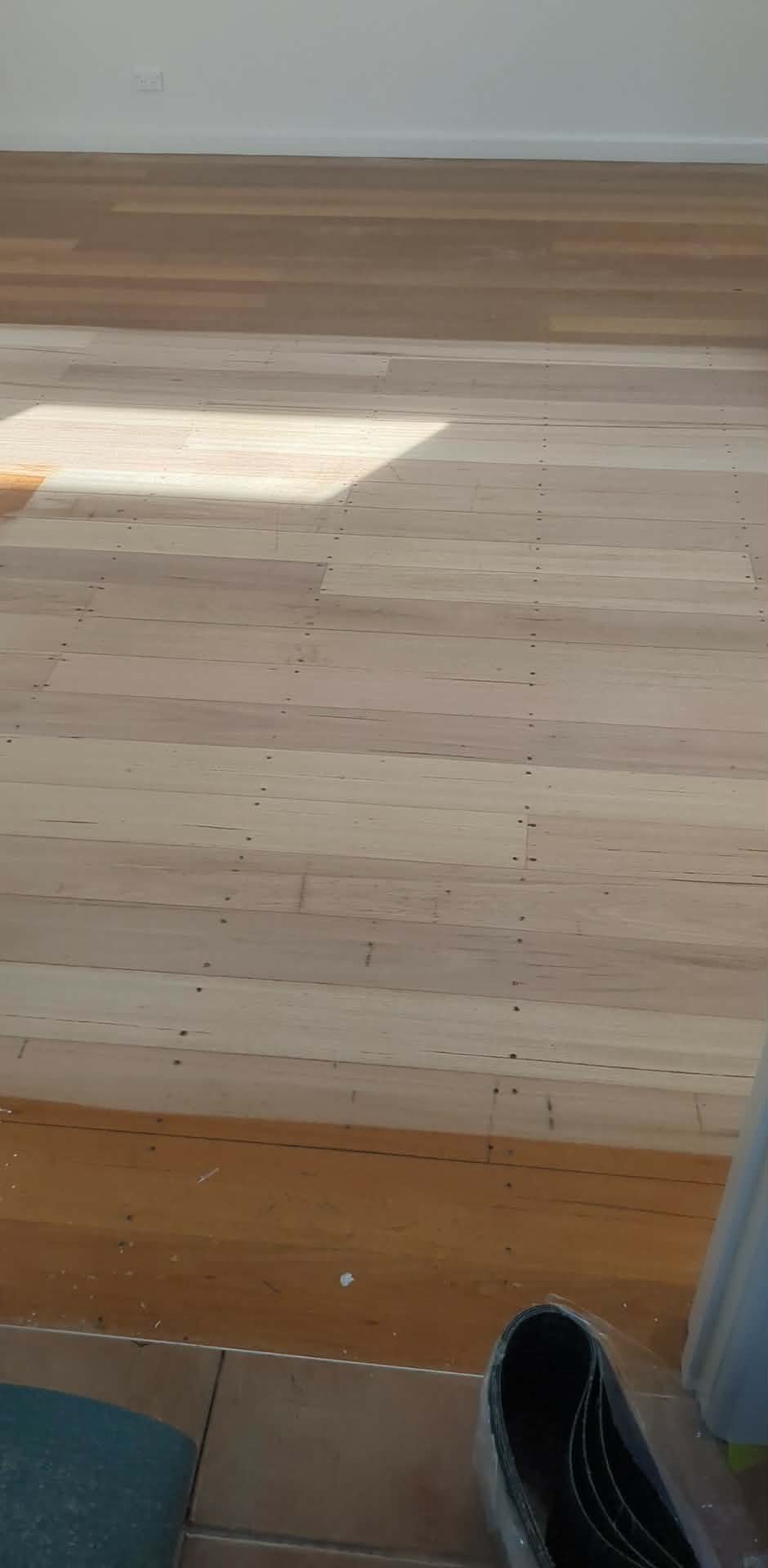 Hardwood timber floor mid-project after sanding back through progressive grits
