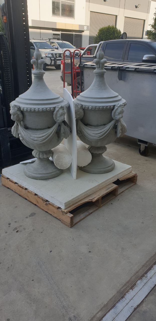Restored cast urn finials with garland and cherub detail ready for installation, Melbourne VIC