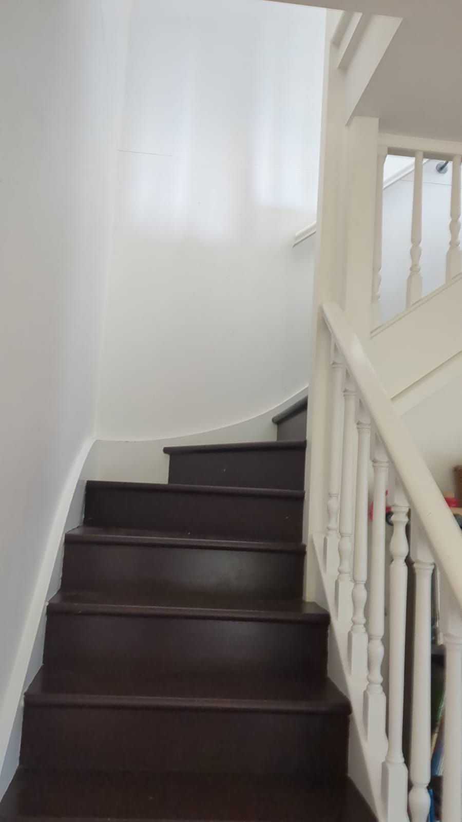 Existing brown timber staircase in the Newport home before painting