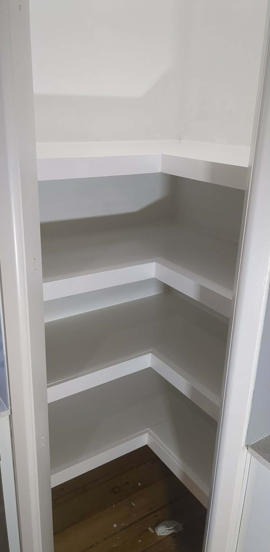 The same corner after plaster repairs, sanding and painting to a clean white finish