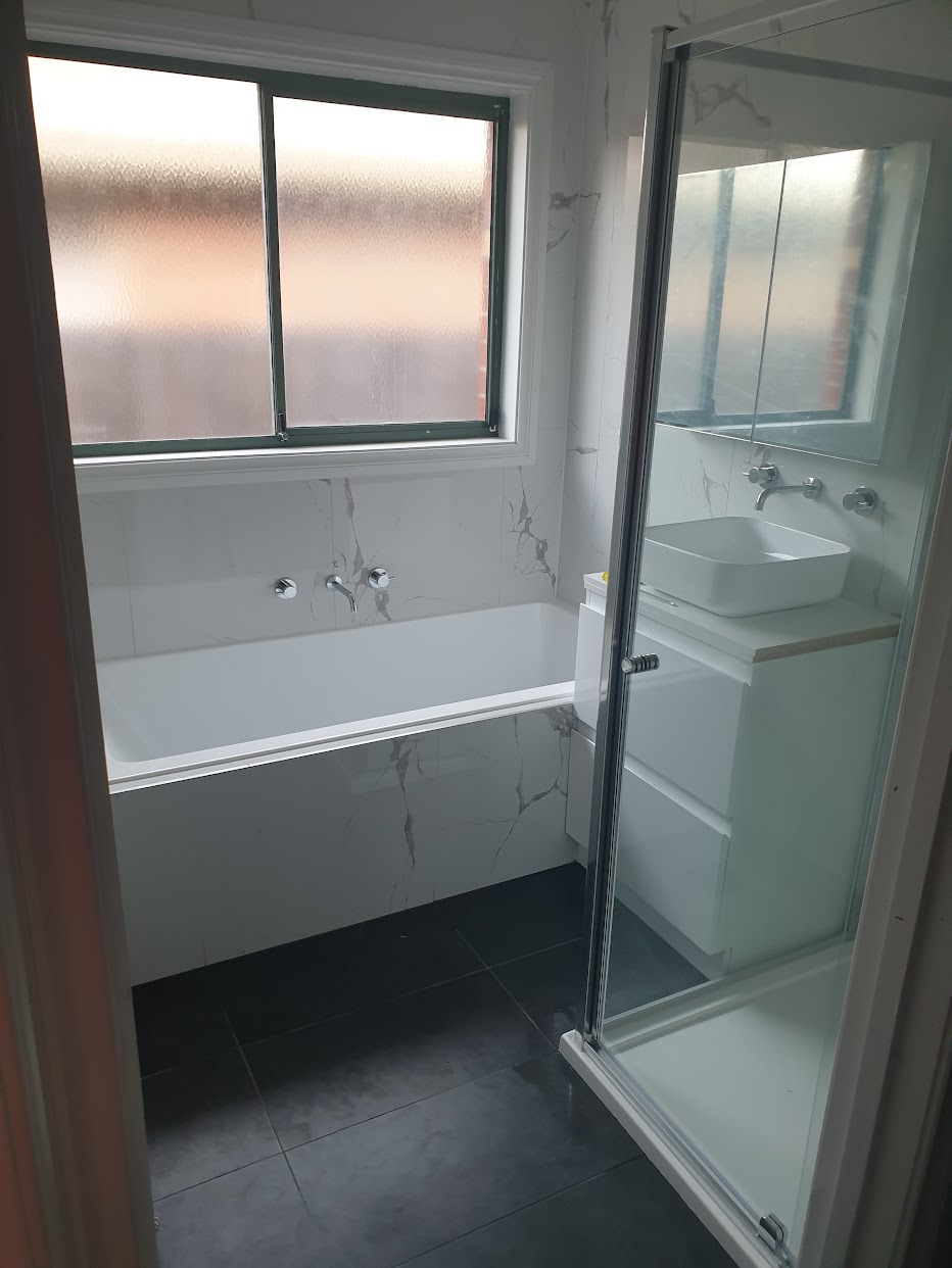 Completed bathroom renovation with vanity, cabinetry and bath — MMR renovation carpentry Melbourne