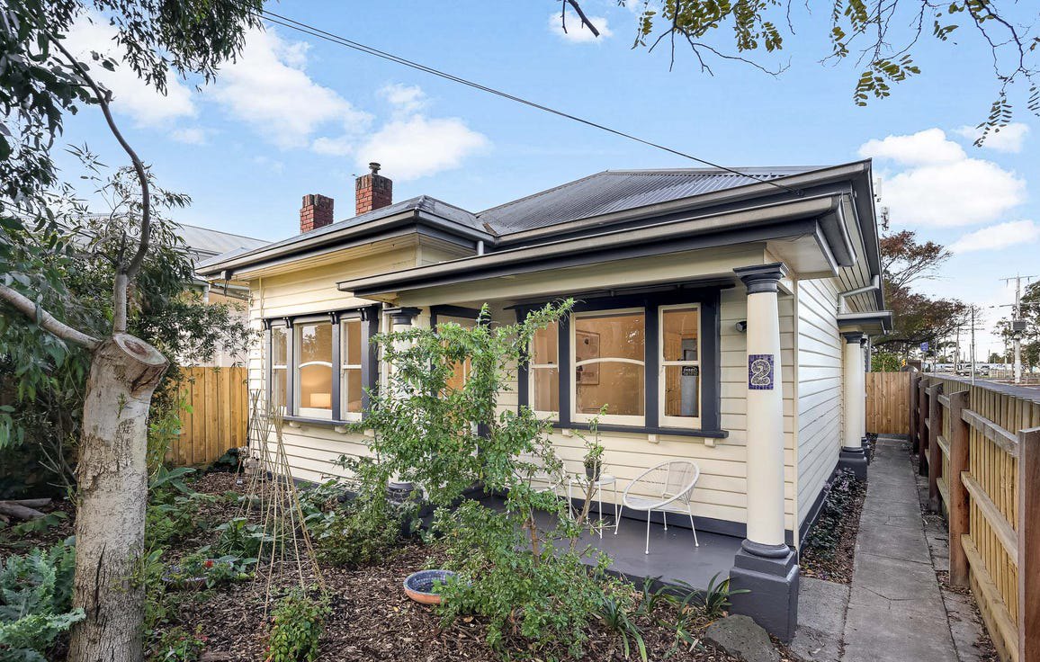 Restored weatherboard front elevation in Newport with repainted boards, window frames and porch columns