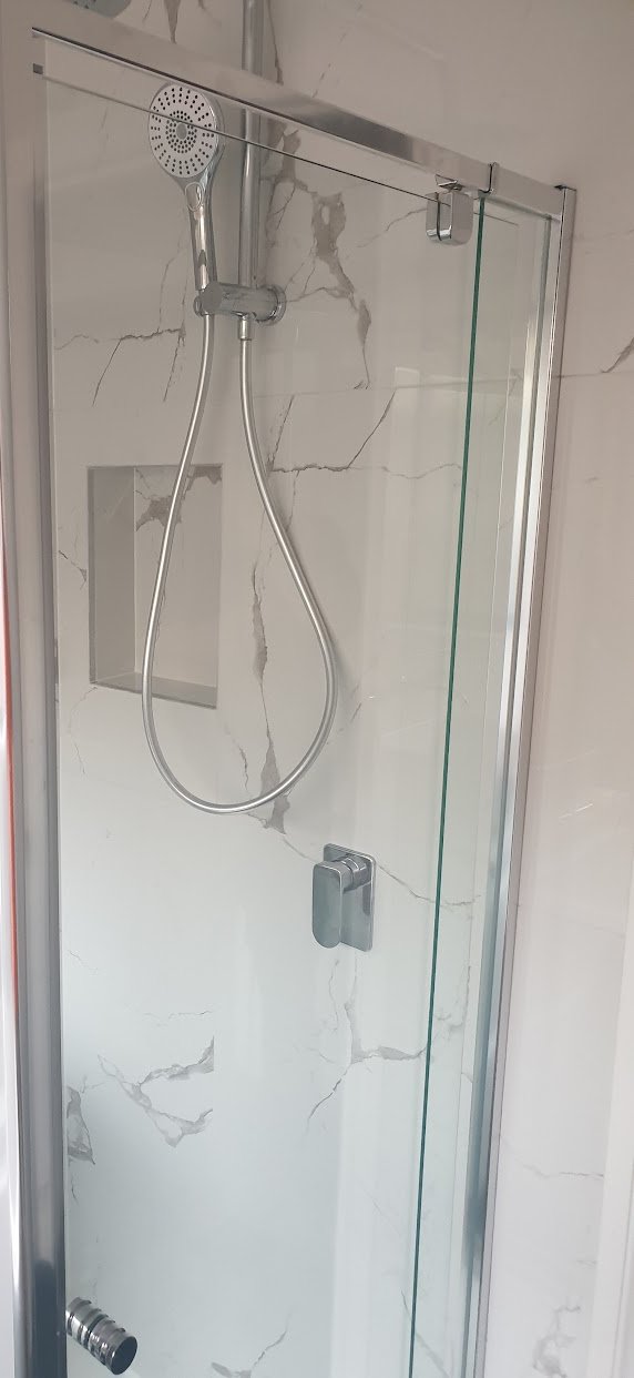 New glass shower screen, rail shower and recessed niche over marble-look wall tiles