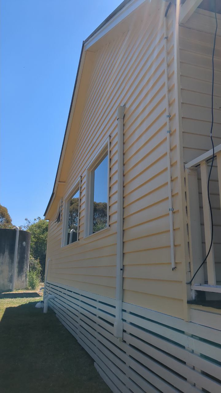 Exterior weatherboard painting in heritage cream, Lauriston Victoria