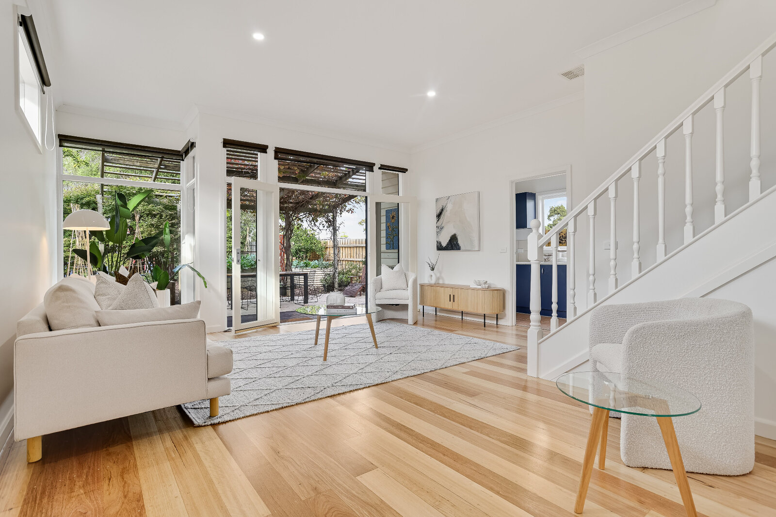 Open-plan lounge repaint with bright white walls and timber floors at 2 Derkin Street, Newport VIC